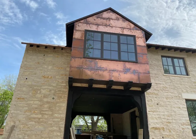 Copper metal panel facade on a stone building for Skylight Installation in Millburn